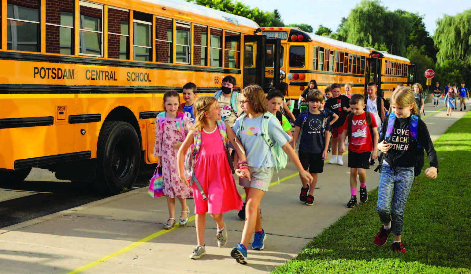 students walk past a Potsdam CSD bus