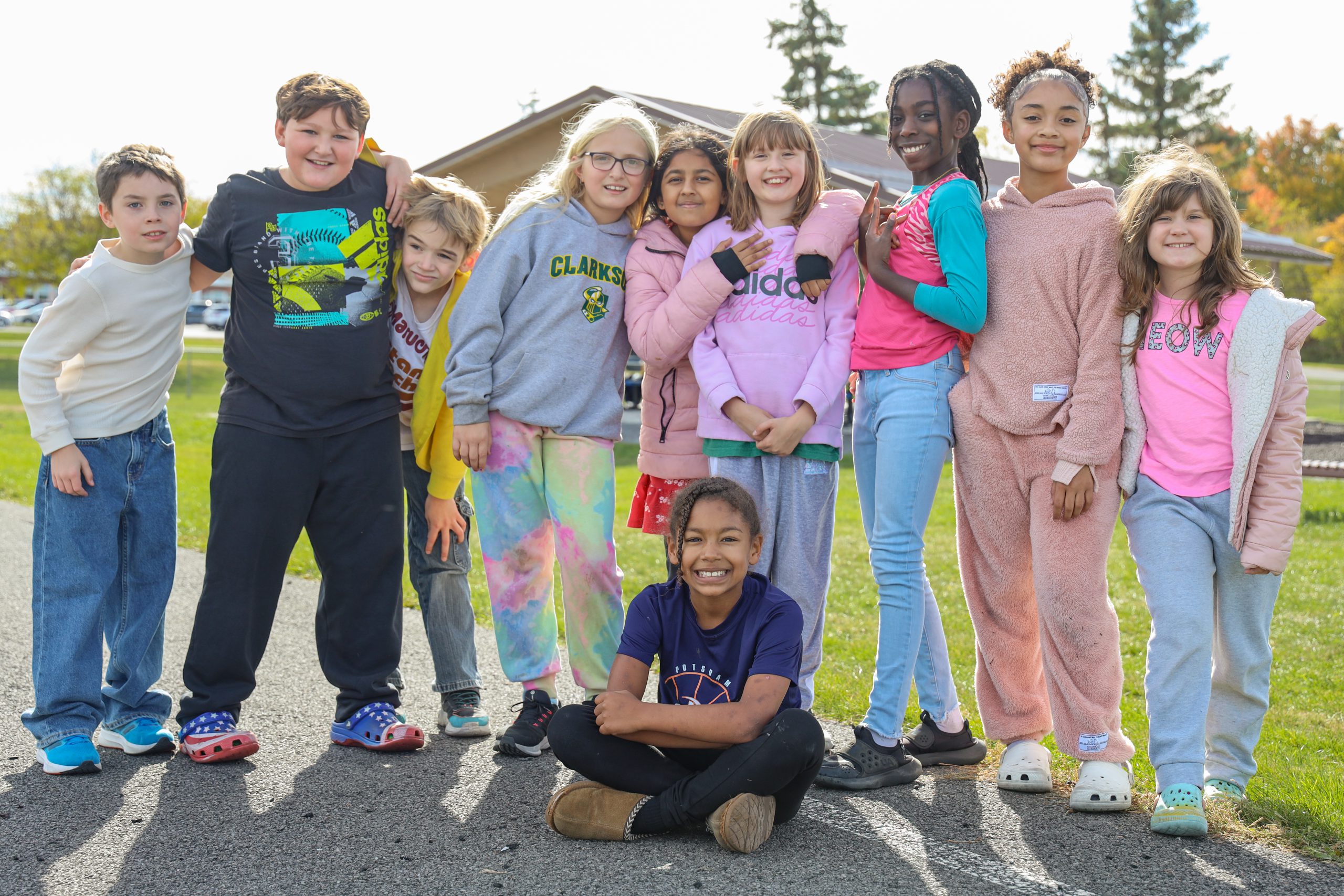Group of elementary school students smile at the camera during recess 