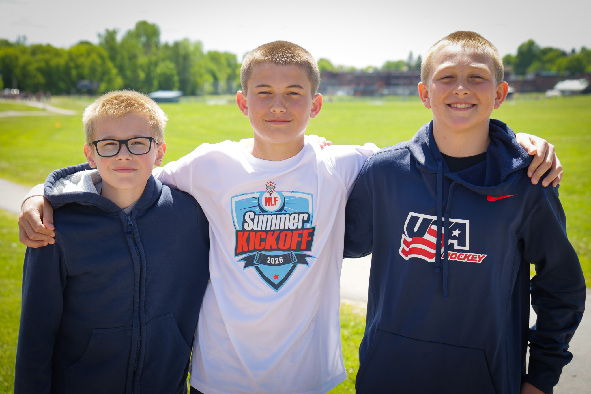 Three middle school boys smile for camera