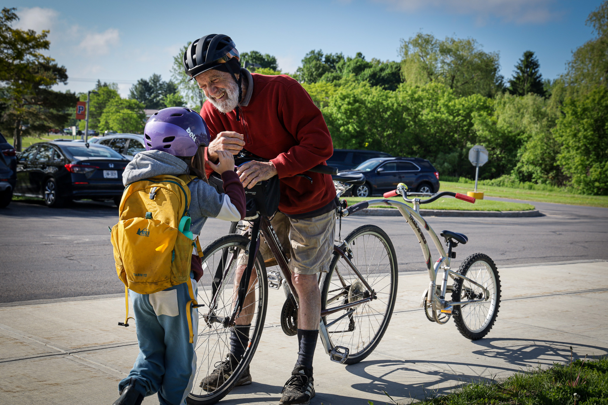 Elementary student greets man on bike 