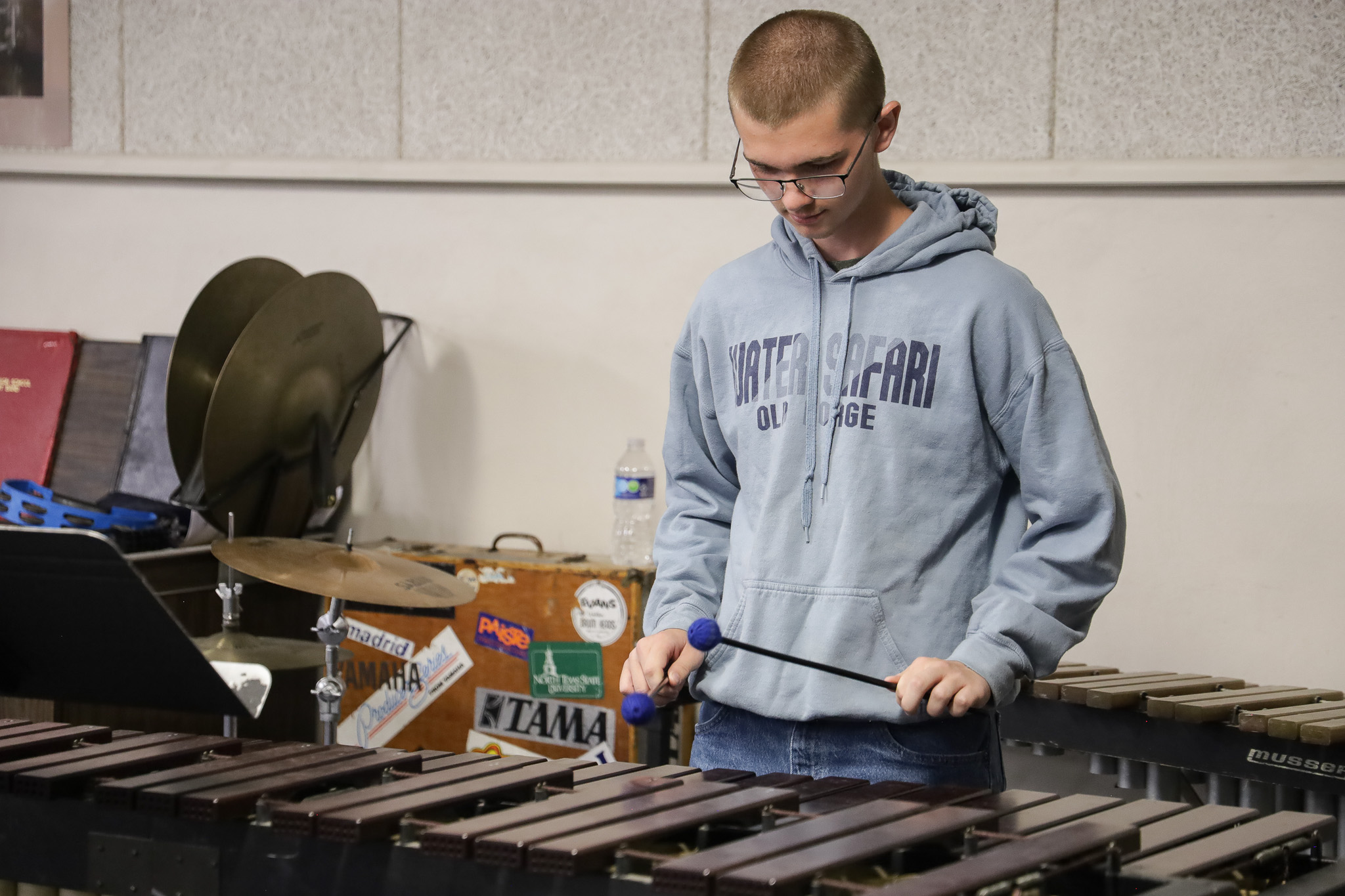 Highschool percussion student practices in band 