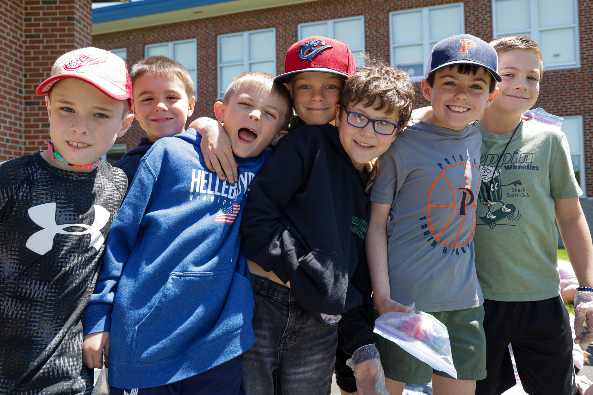 Group of elementary school boys smile big at camera