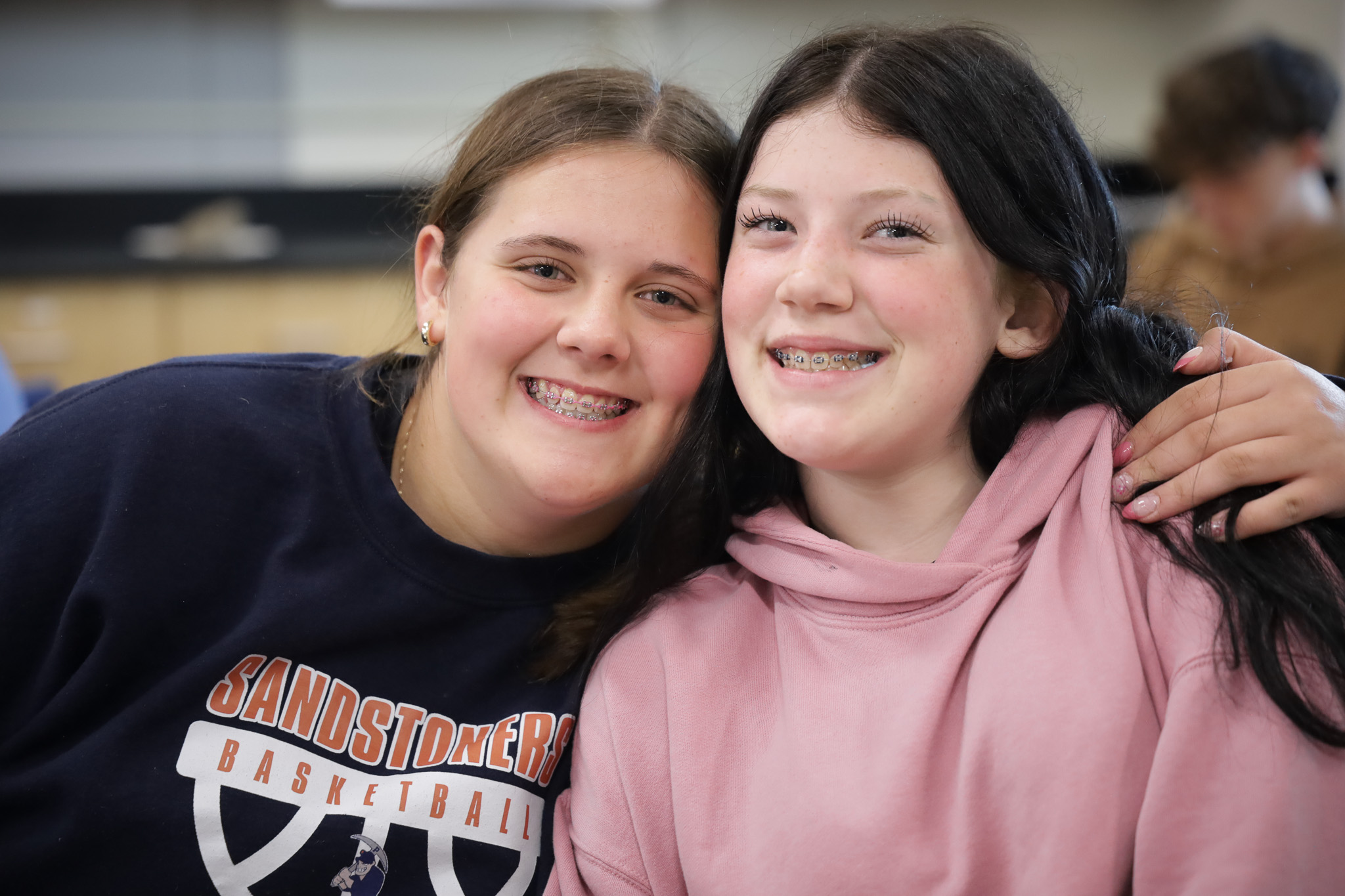 Two middle school girls smile for photo 